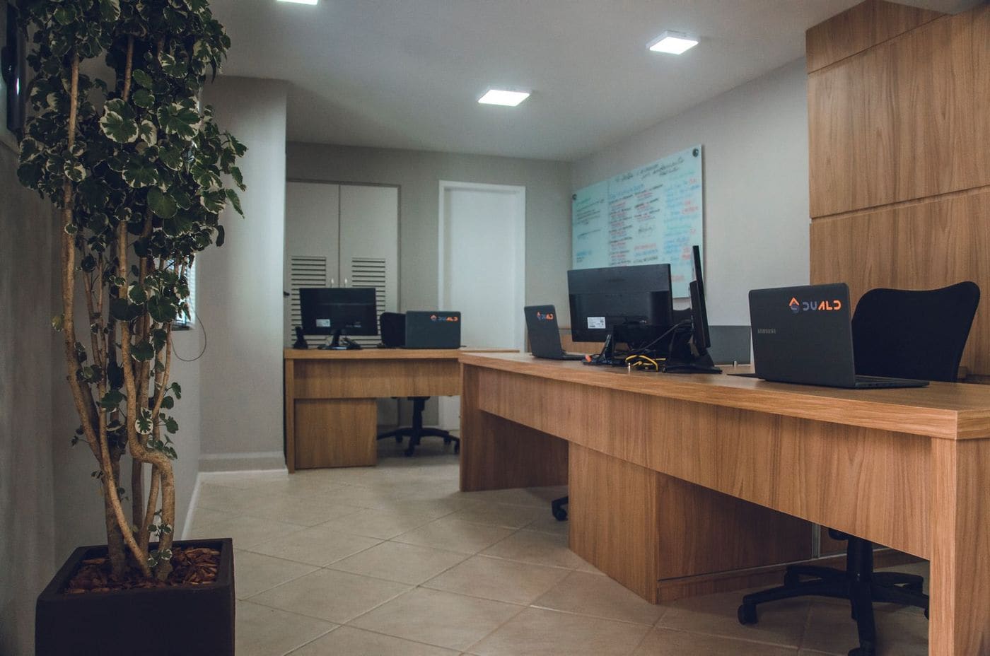 Office interior with wooden desks and daylight